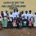 Group photo at Church of God's Five Loaves Children Center, with women and children smiling, Sierra Leone.