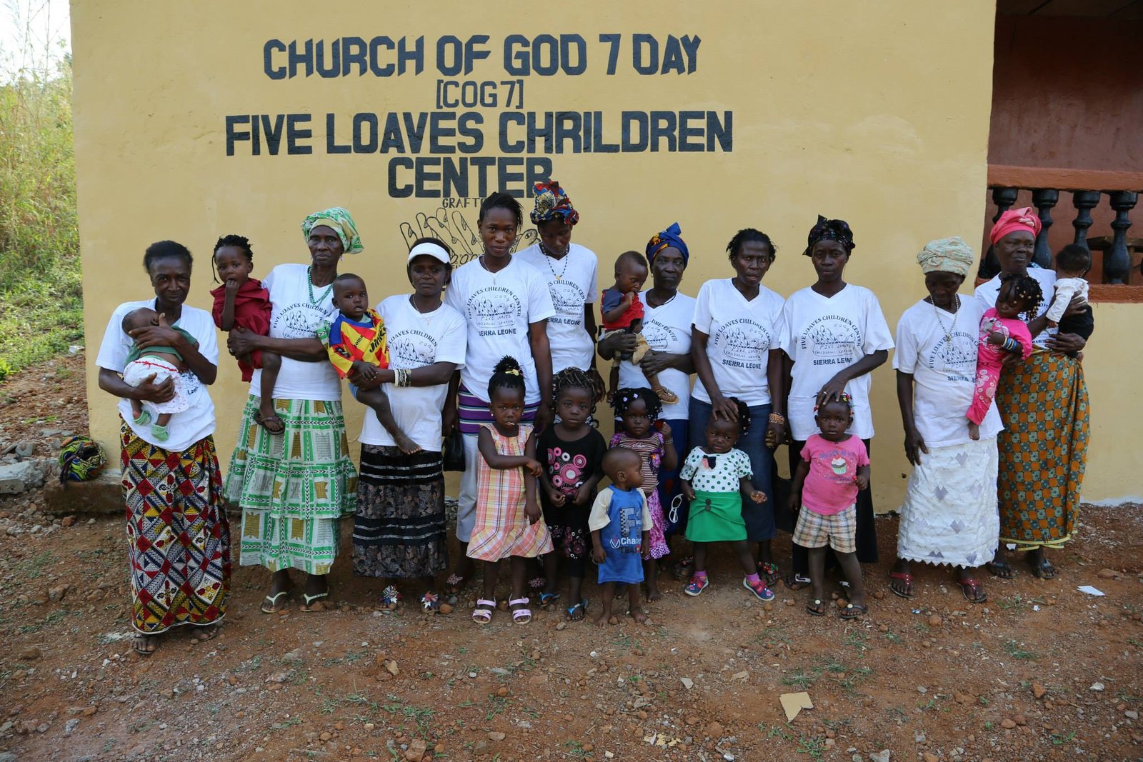 Group photo at Church of God's Five Loaves Children Center, with women and children smiling, Sierra Leone.