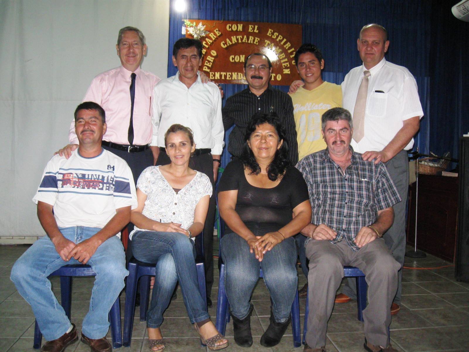 Group photo of ten people at a gathering, smiling in a casual setting.